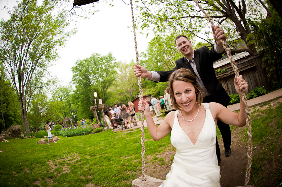 cute bride and groom on a swing at wedding