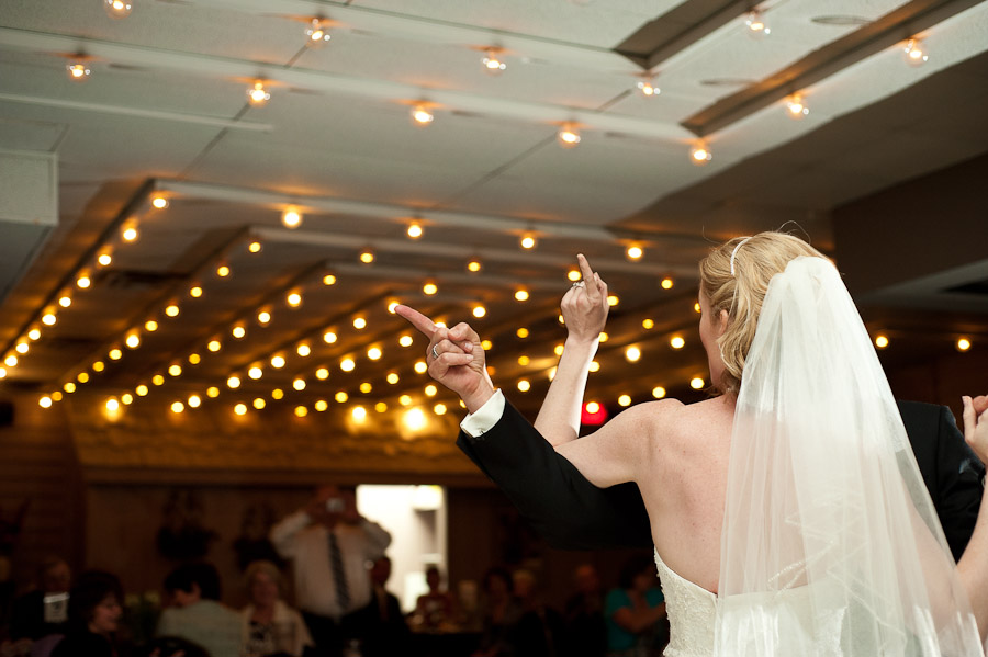 funny first dance photo of bride and groom pointing fingers