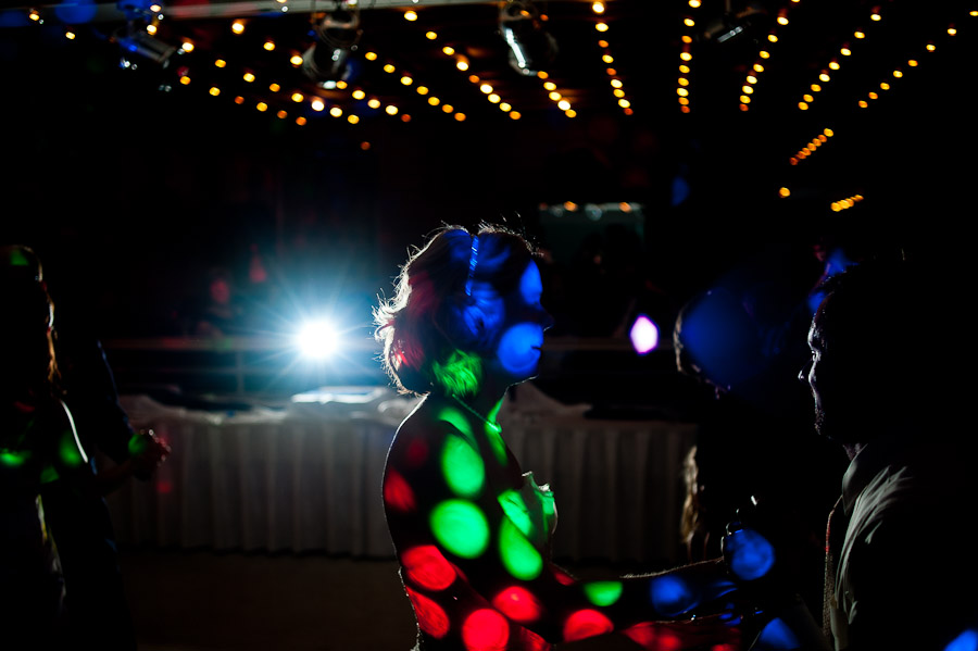 hilarious quirky photo of bride covered by DJ lights 