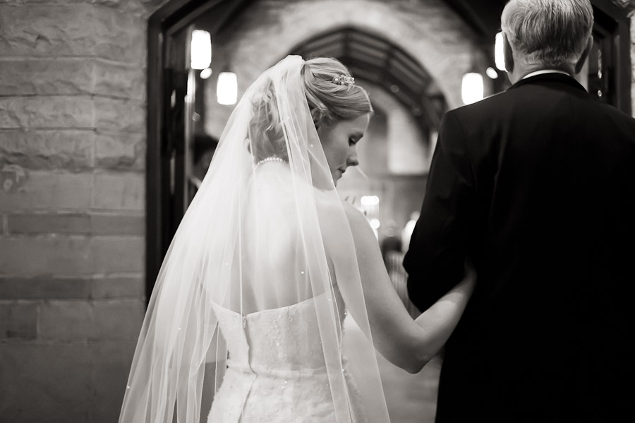 bride waiting with father before walking down aisle