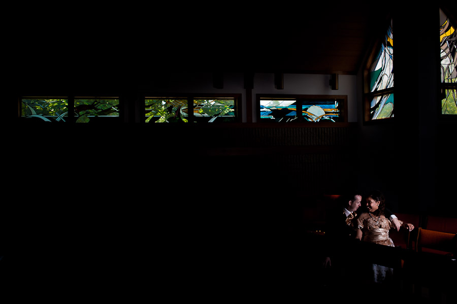 intimate strobist bride and groom portrait with stained glass