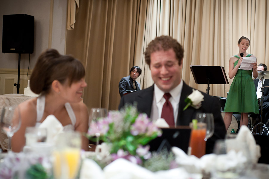 funny moment of bride and groom laughing during toast