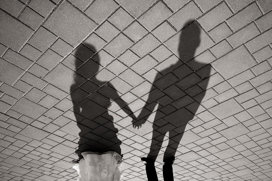 Creative wedding portrait of shadows and bricks