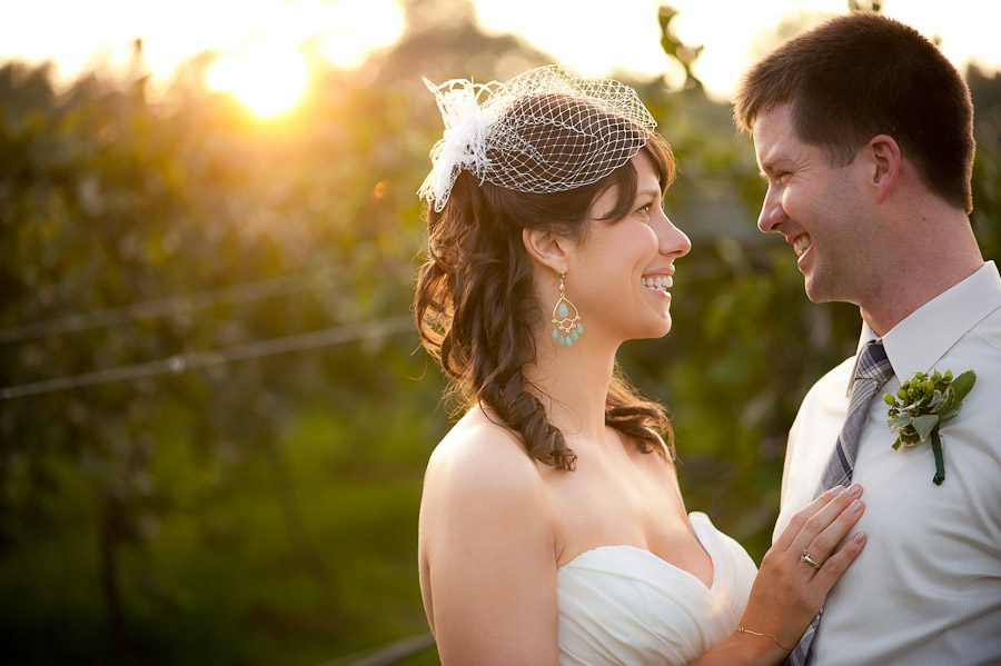 bride and groom smiling at sunset