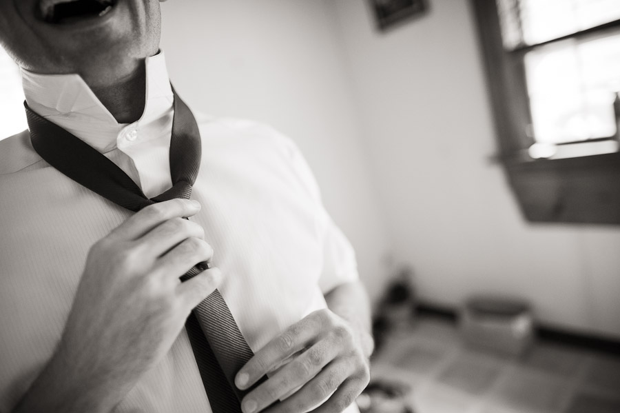 Guy tying tie