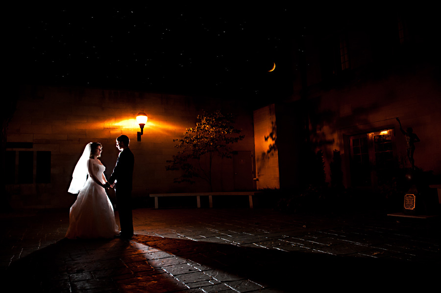 Moonlit nighttime portrait of wedding couple bride and groom at Indiana Memorial Union in Bloomington Indiana