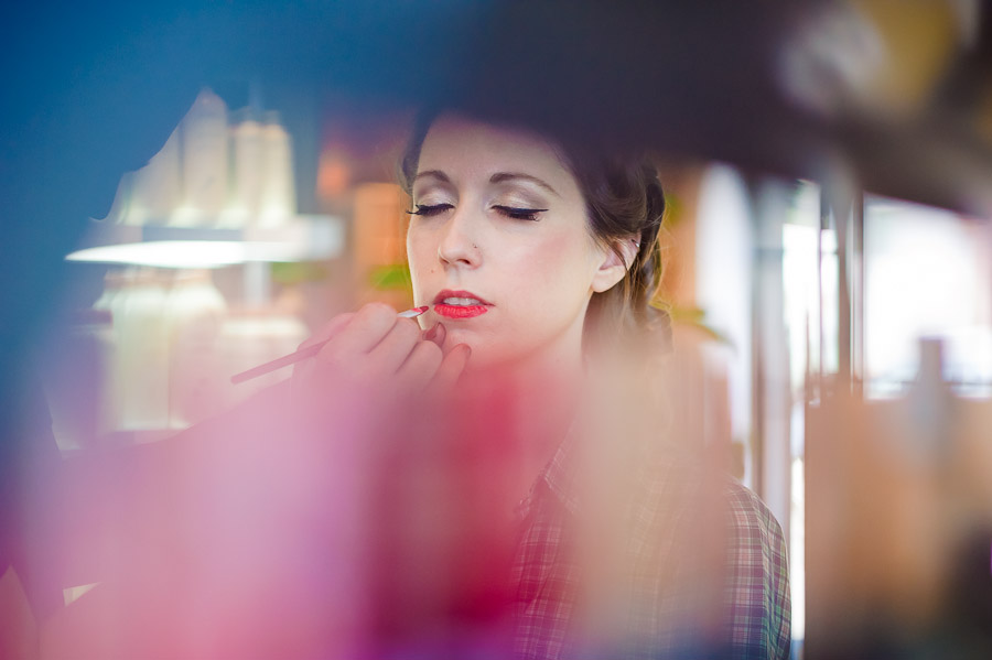 Bride getting makeup and hair done before wedding