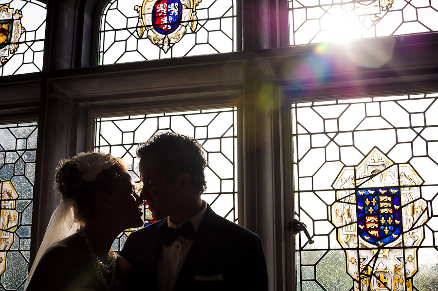 Romantic, sun flare portrait with stained glass at Laurel Hall