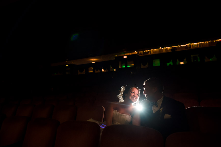 Creative and fun portrait of wedding couple in theater