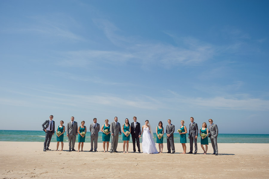 Quirky and colorful bridal party photo on beach at Lake Michigan