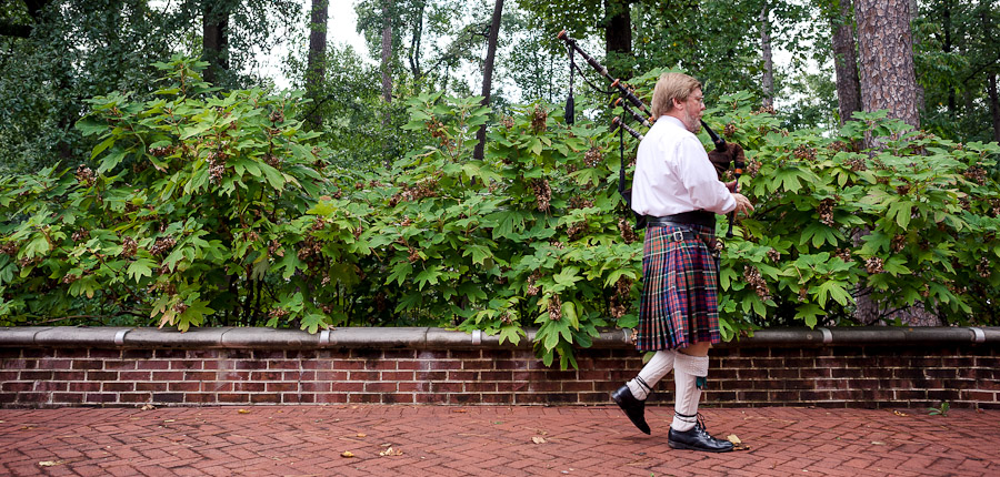 Sweet bagpiper piping at destination wedding