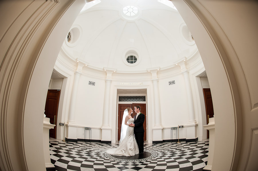 Gorgeous wedding couple in domed cathedral with checkered floor