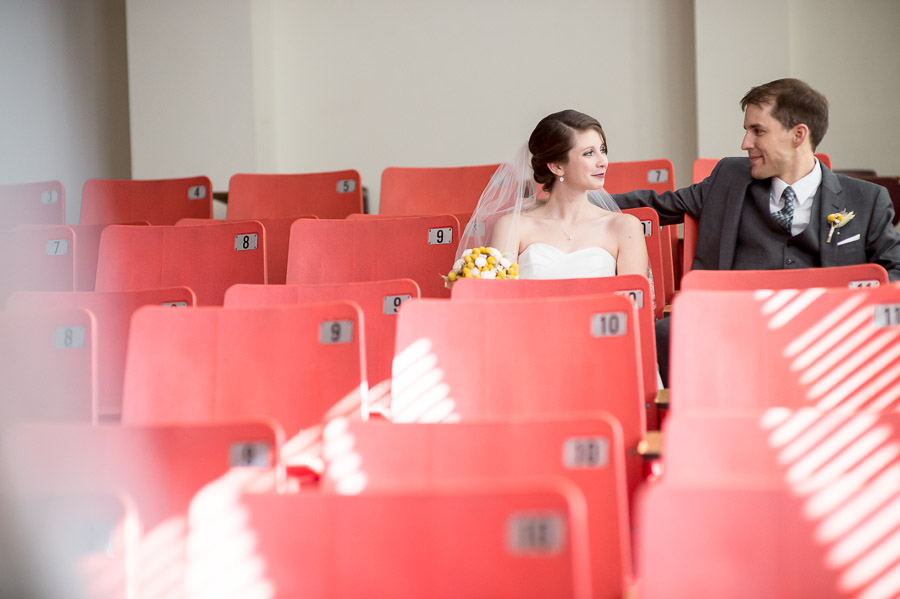 quirky and fun photo of wedding couple in classroom on Indiana University campus 