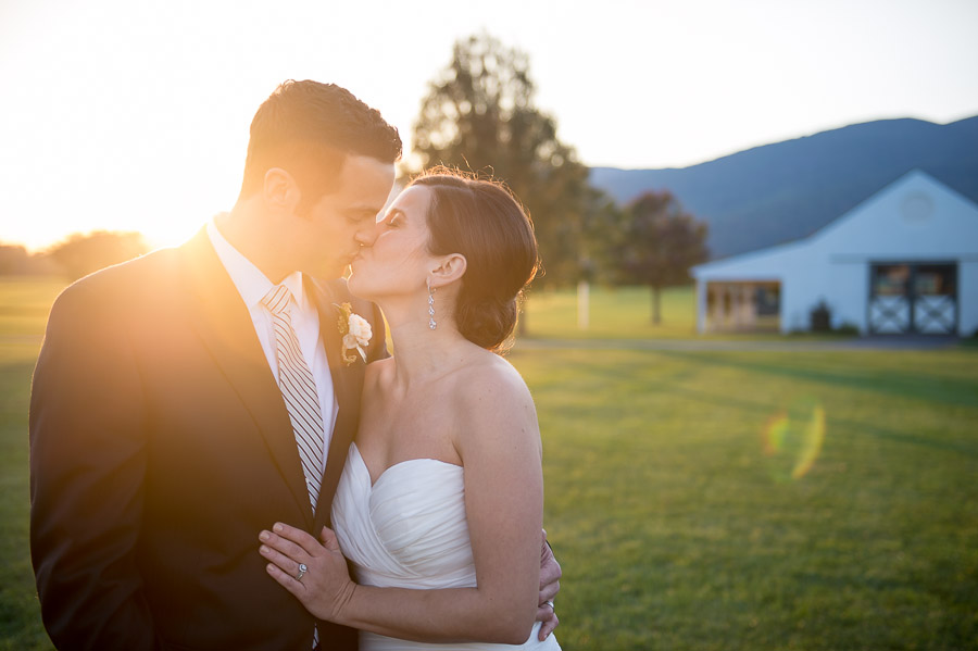 Breathtaking, sunny smooch photo at Charlottesville, VA wedding