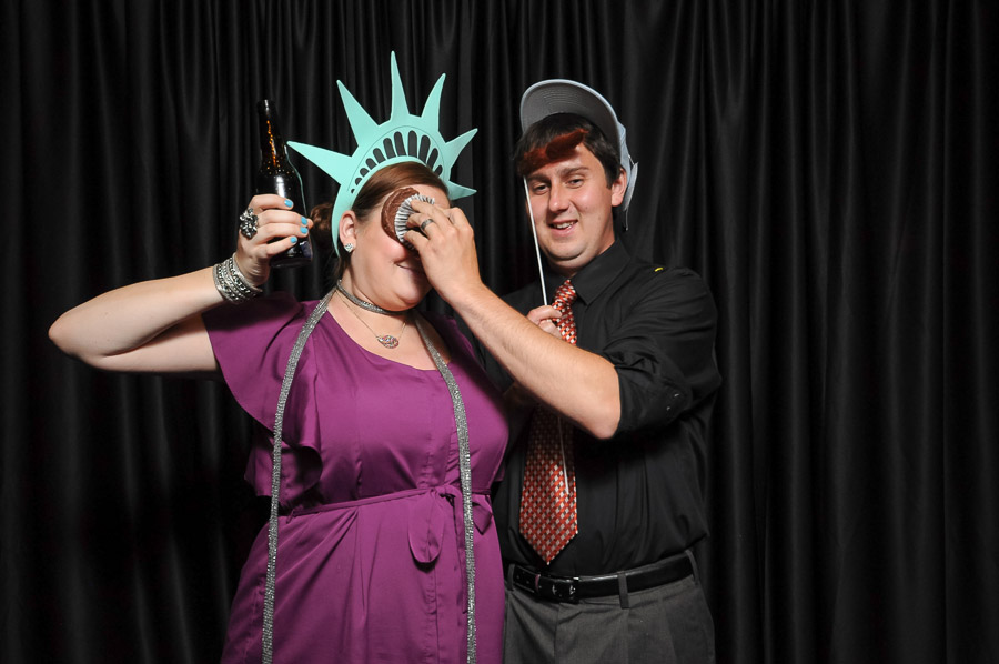 Funny couple in Indianapolis photobooth pic with smashed cupcake