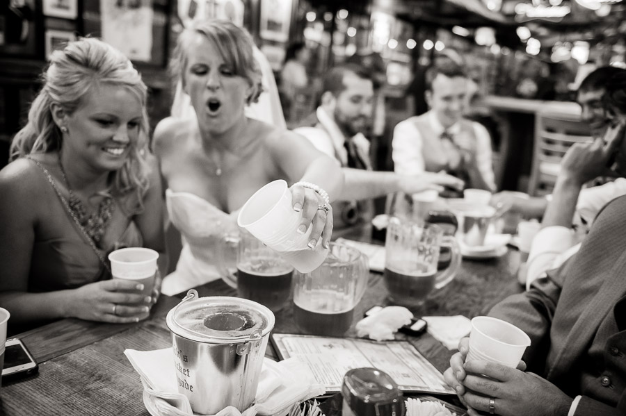 Bride and groom sinking the biz at Nick's on their wedding day in Bloomington, Indiana