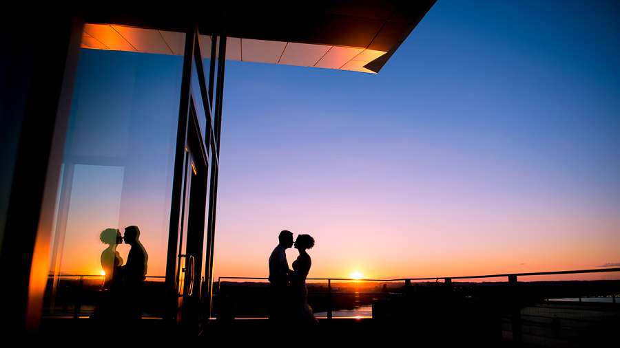 Beautiful, colorful, silhouette wedding portrait at sunset in Louisville, Kentucky at the ali center