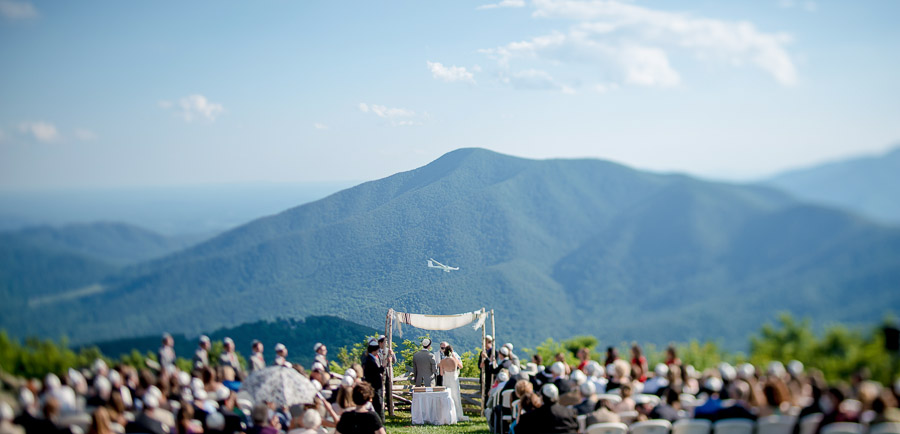 amazing wedding moment at wintergreen overlook with glider flying through mountains