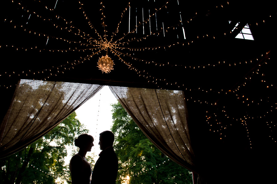 fun and dramatic silhouette photo of bride and groom at Indiana barn wedding