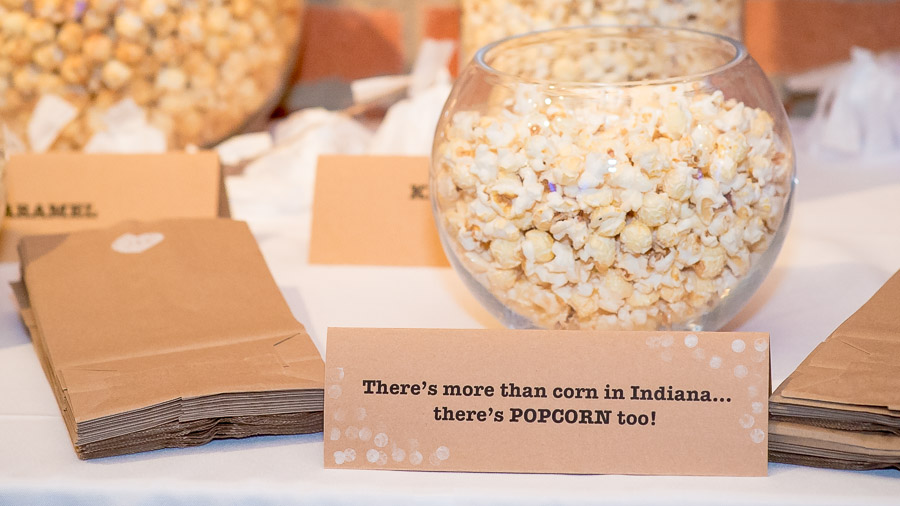 Funny, creative flavored popcorn table at Indiana wedding