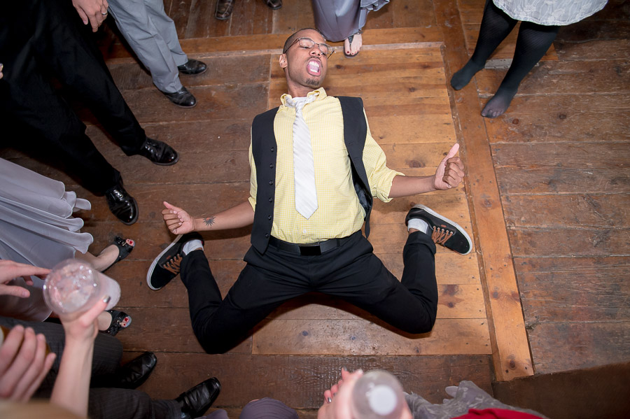 awesome photo of wedding guest break dancing on dance floor at Noblesville, Indiana wedding