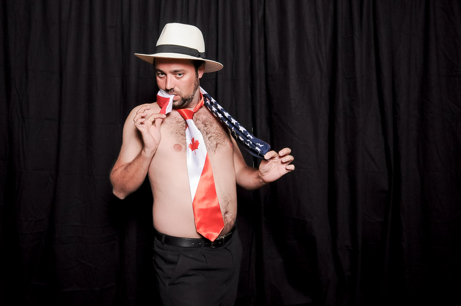 Very funny photobooth photo of shirtless guy with Canadian tie at Virginia wedding