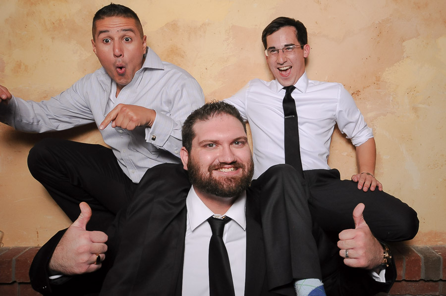 Strongman lifting two guys in photobooth photo at Bloomington, Indiana wedding