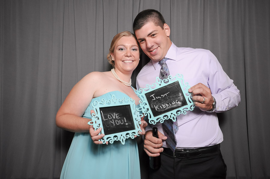 Very funny photobooth photograph with chalkboards and gray background at Indiana wedding