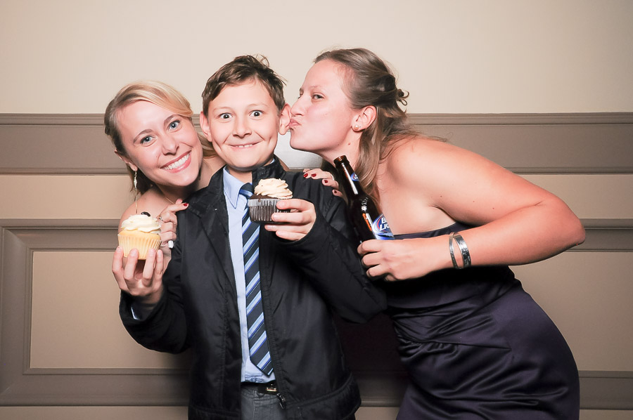 Cute photobooth photo of happy boy getting kisses and cupcakes! At wedding in Richmond, Virginia.