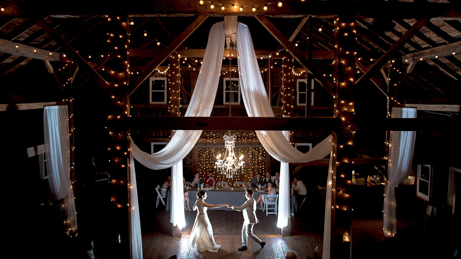 Gorgeous first dance photo in beautifully lit barn at Indiana wedding by TALL + small Photo