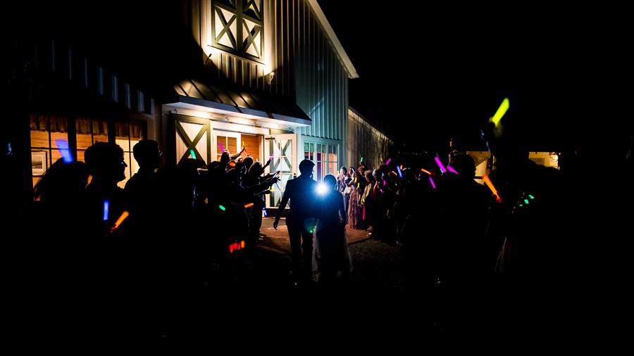 Fun, nighttime wedding exit with glow sticks at King Family Vineyard winter wedding