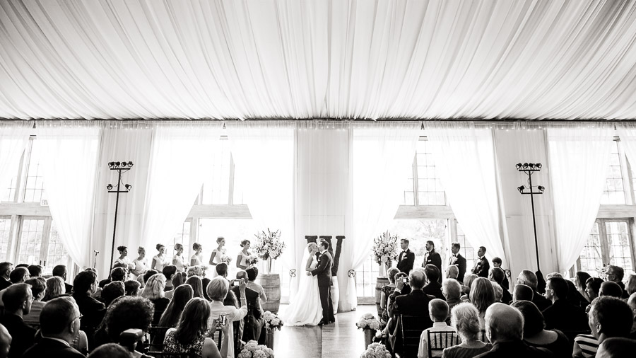 First kiss photo indoors at Veritas Vineyards wedding ceremony by Tall and Small Photography