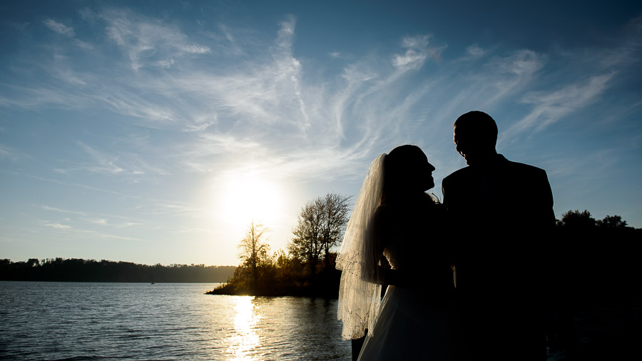 Gorgeous bride and groom portrait with sunset on Lake Monroe