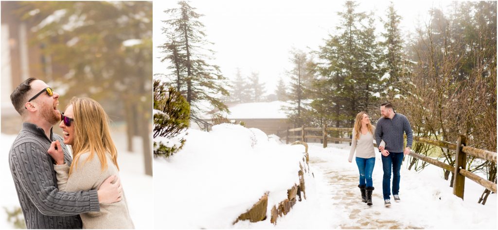 Couple walking and cuddling in the snow at their engagement shoot.