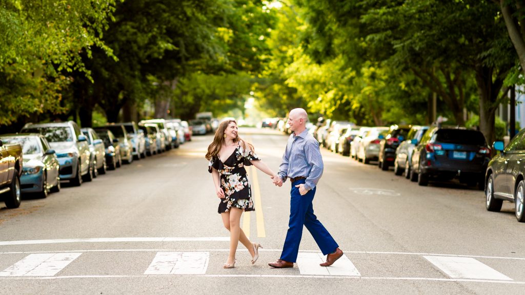 Becky and Rob crossing the street in the Fan for their Richmond engagement pics