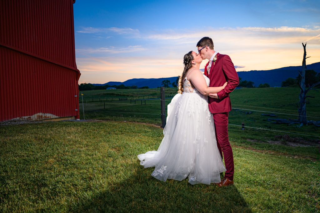 Nighttime wedding portrait of couple near barn for their Rockingham County Wedding photography