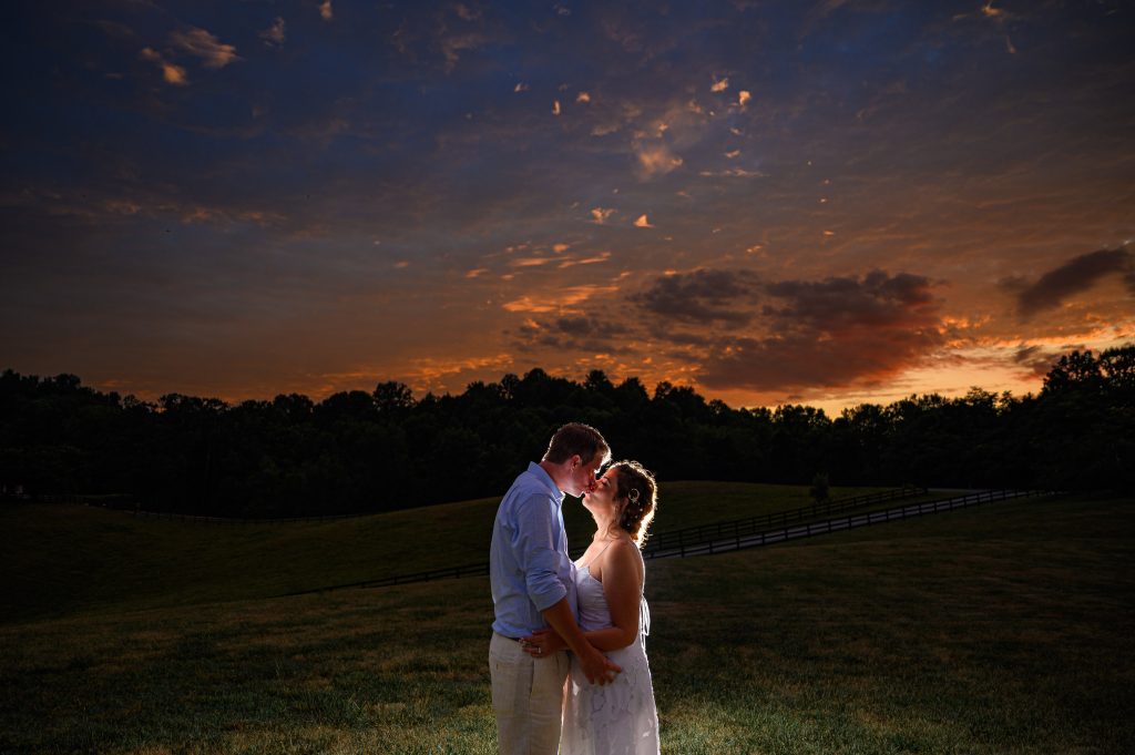 Couple backlit with a dramatic sunset at their Sperryville wedding photography