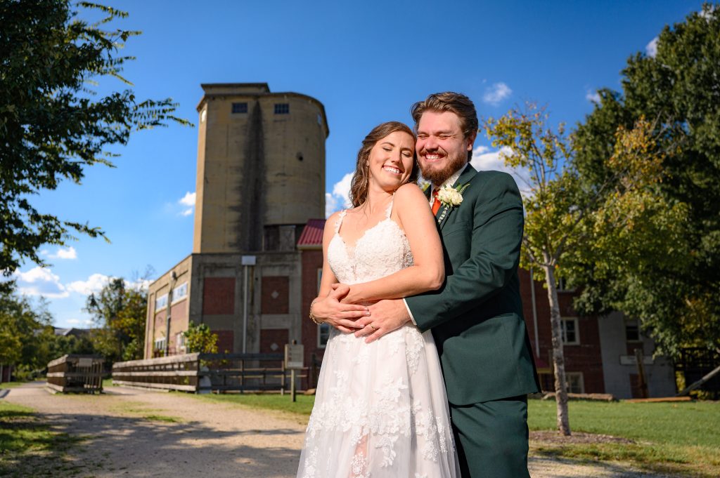 Couple in front of the Farmville Mill at their wedding