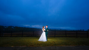 Couple backlit at night on a rainy and beautiful day for their Rivercrest wedding photography in Elkton, VA
